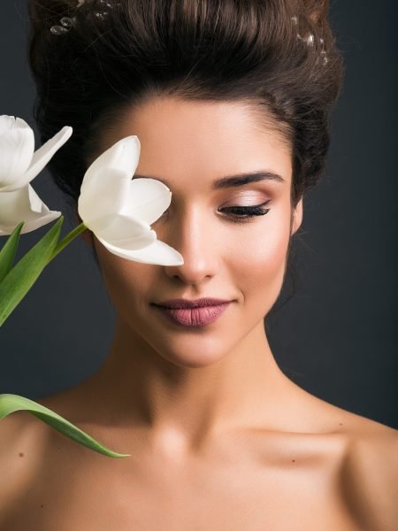 young beautiful stylish woman, bride, bridal fashion, spring trend, flowers, tulips, hairstyle, beauty make-up, white dress, tenderness, innocence, dark background